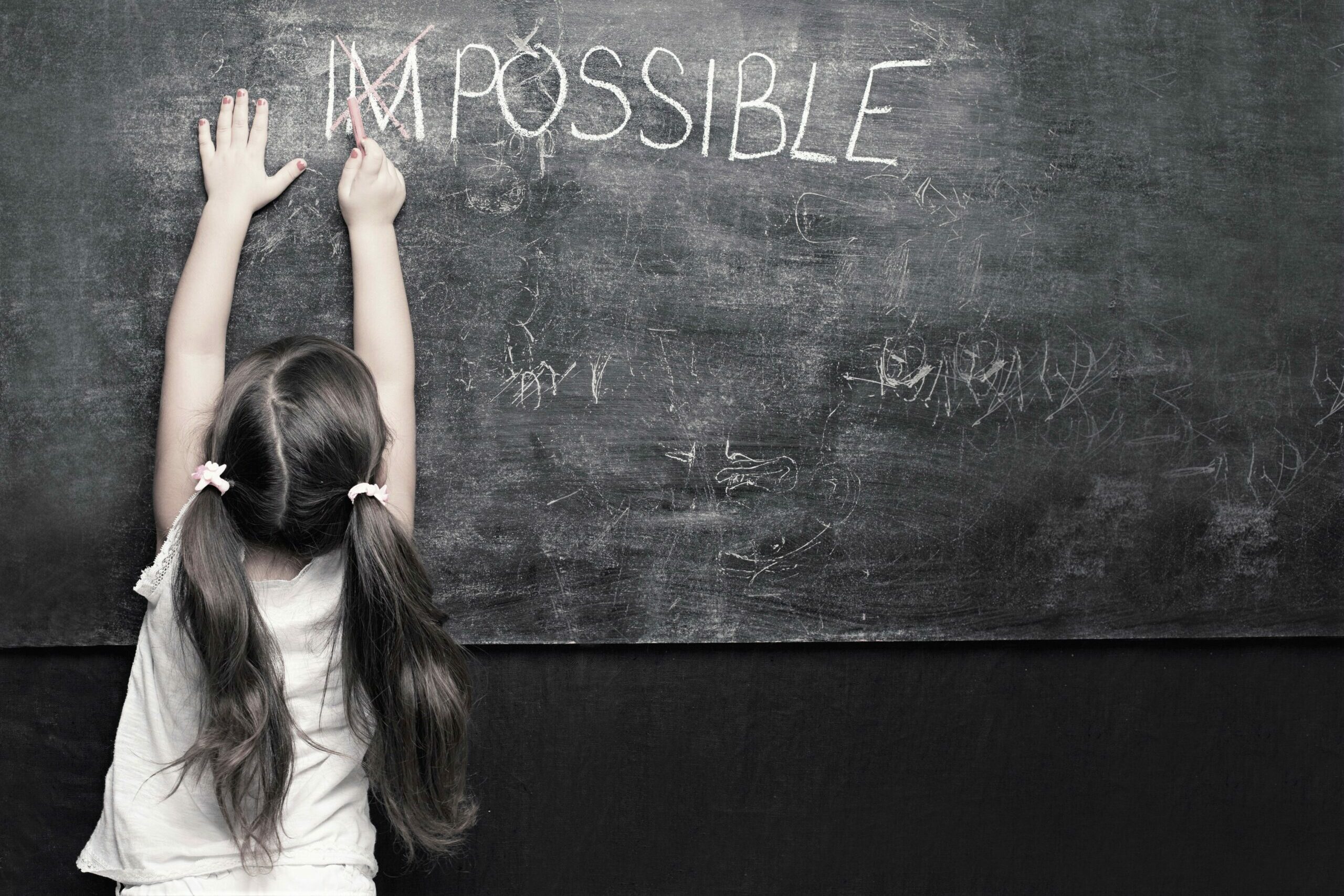 Cute,Little,Girl,Putting,A,Cross,Over,Impossible,On,Blackboard
